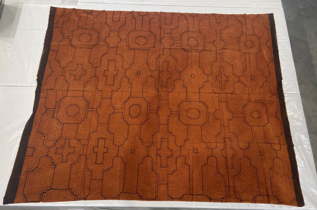 Twentieth-century Shipibo-Conibo textile with dark geometric lines on a reddish-brown ground, Princeton University Art Museum TC2022.65.3