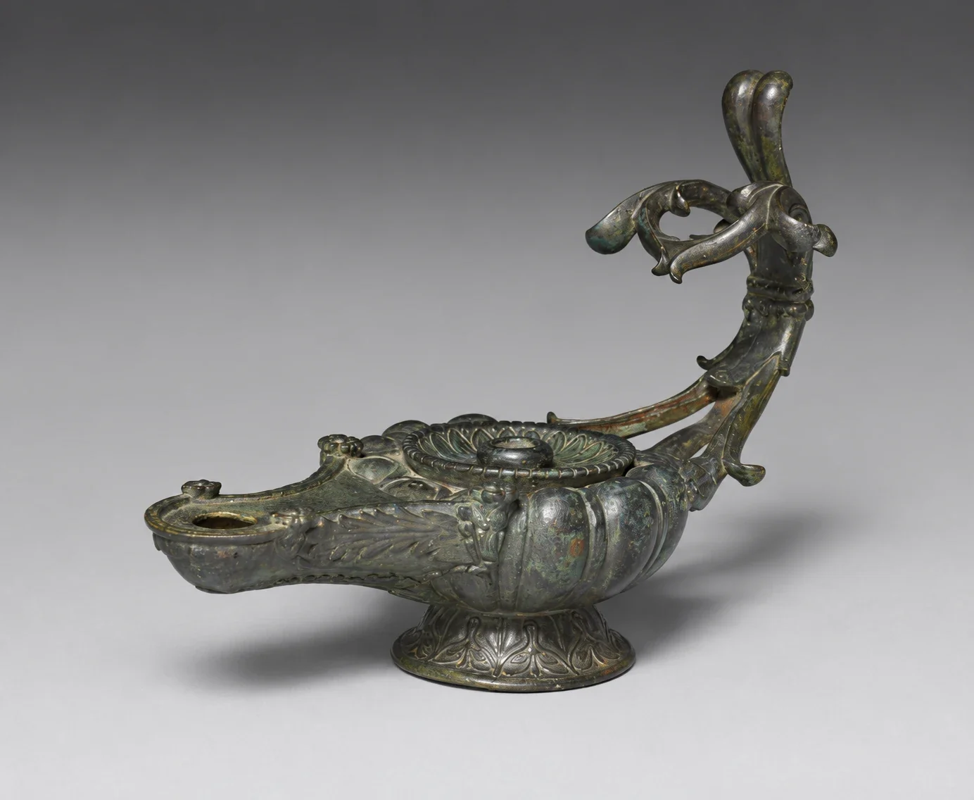 Bronze oil lamp with complete ornate handle.