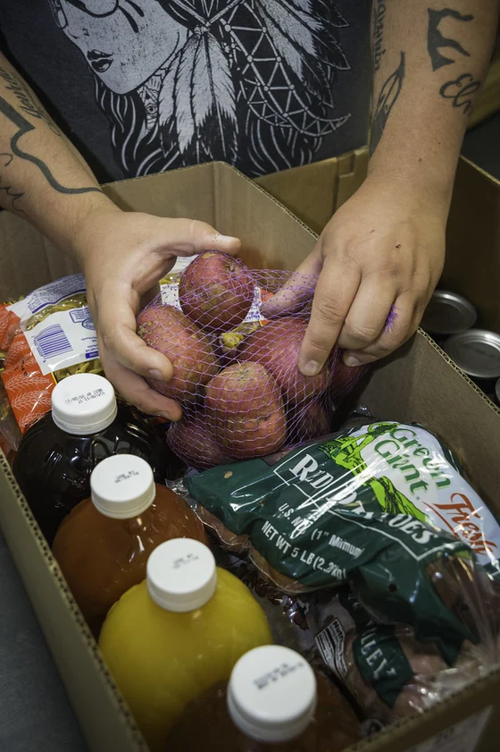 Joseph Jordan packing requested foods at the Oneida Nation Food Distribution Center in Oneida, Wisconsin, photographed by USDA’s Bob Nichols on 10 September 2014