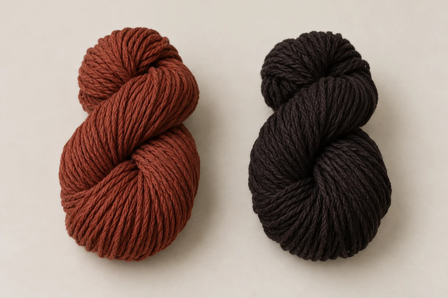 Plain reddish-brown and dark cotton yarn bundles.