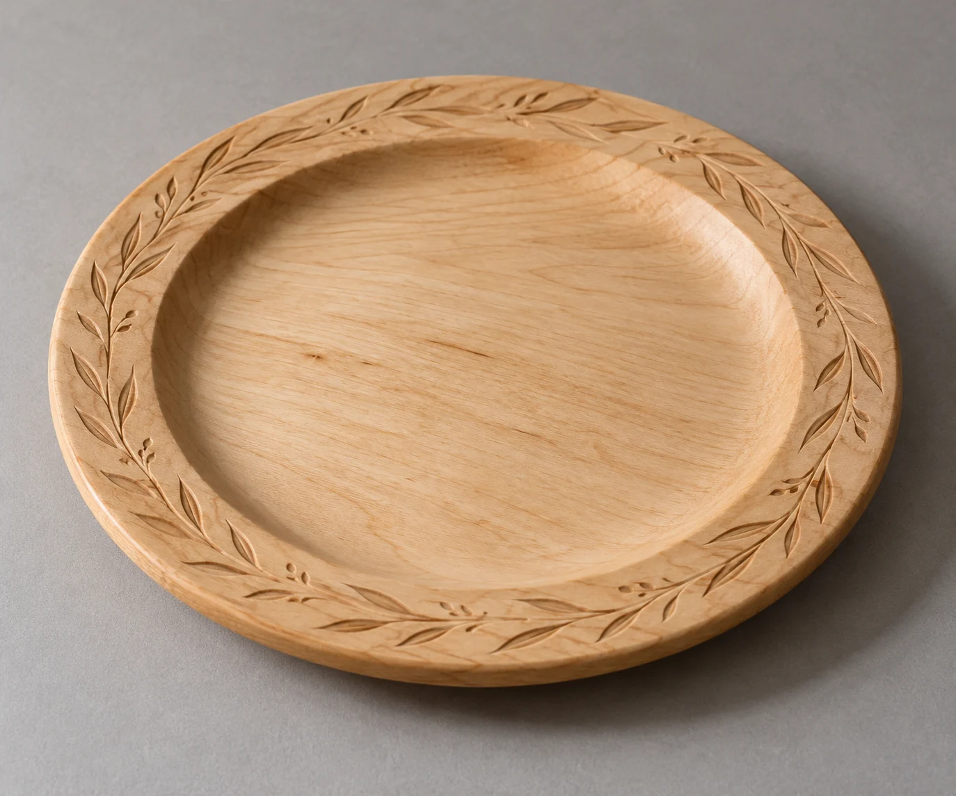 Wooden bread plate with shallow carved ornament.