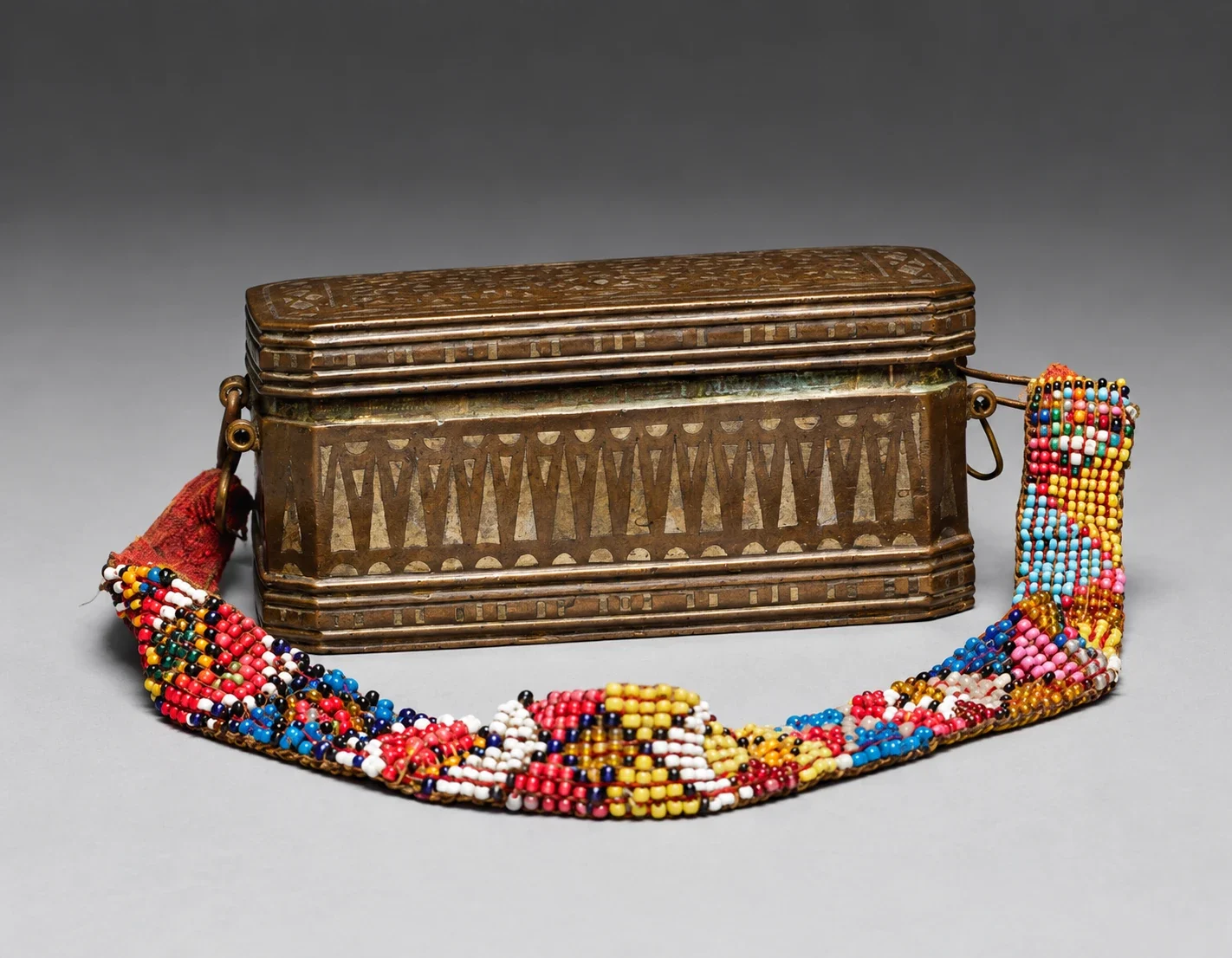 Rectangular betel container with complete beaded strap.