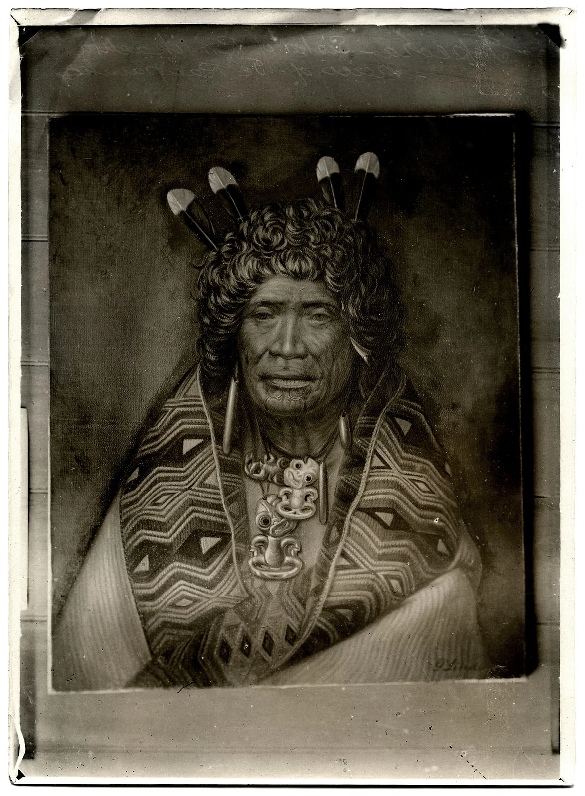 Historical monochrome reproduction of Gottfried Lindauer’s named portrait of Te Rangitopeora, with patterned cloak, hair ornaments and pendants; original photograph borders and wear remain visible.