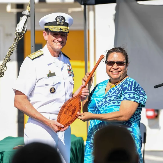 Palau Vice President Uduch Sengebau Senior and U.S. Rear Admiral Gregory Huffman holding a gift aboard USNS Mercy in December 2023
