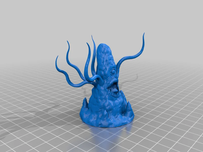 Blue tapered rocklike miniature with one eye, an open toothed mouth and long curling tentacles, standing on a rocky base over a grey grid.