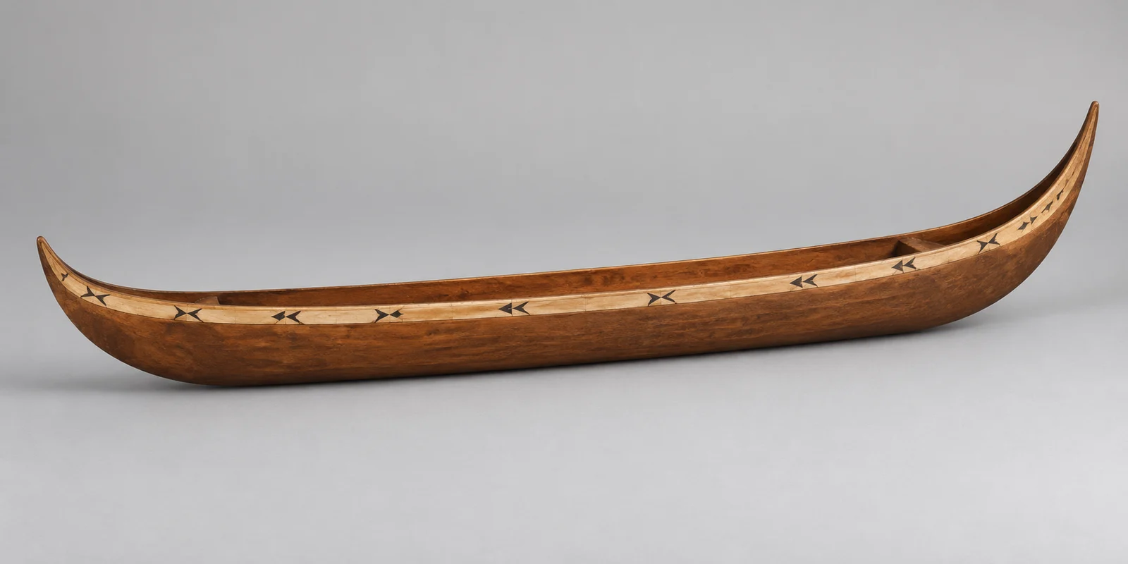 Generated contextual study of Guppy’s illustrated model canoe.