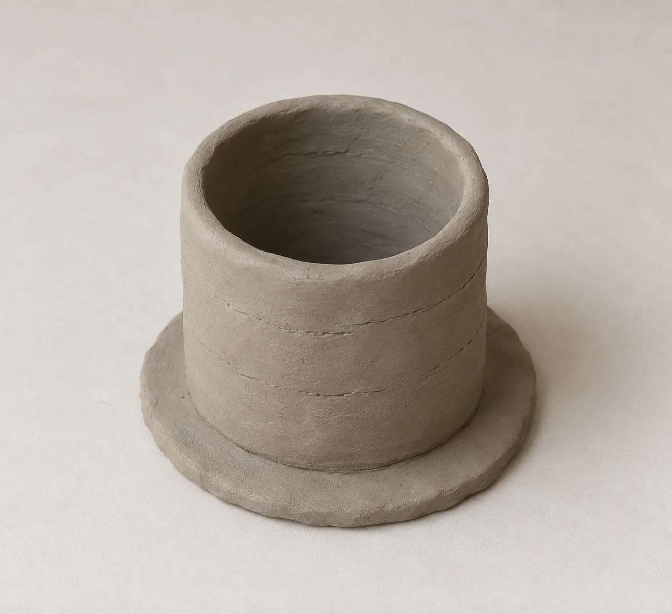 Schematic unfinished coiled clay vessel; no maker or community reconstructed.