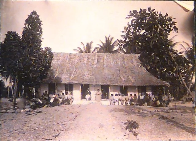 Congregation outside a thatched mission house on Arorae, Kiribati, photographed by Thomas Andrew in 1886, Te Papa O.001250