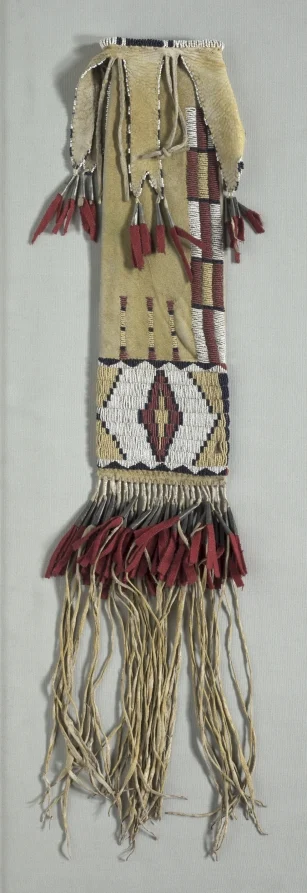Tall bag with geometric beadwork, red tassels and long fringe.