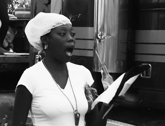 A woman identified as Garifuna by photographer Jimelovski Platano Macho, holding papers in a black-and-white 2010 photograph