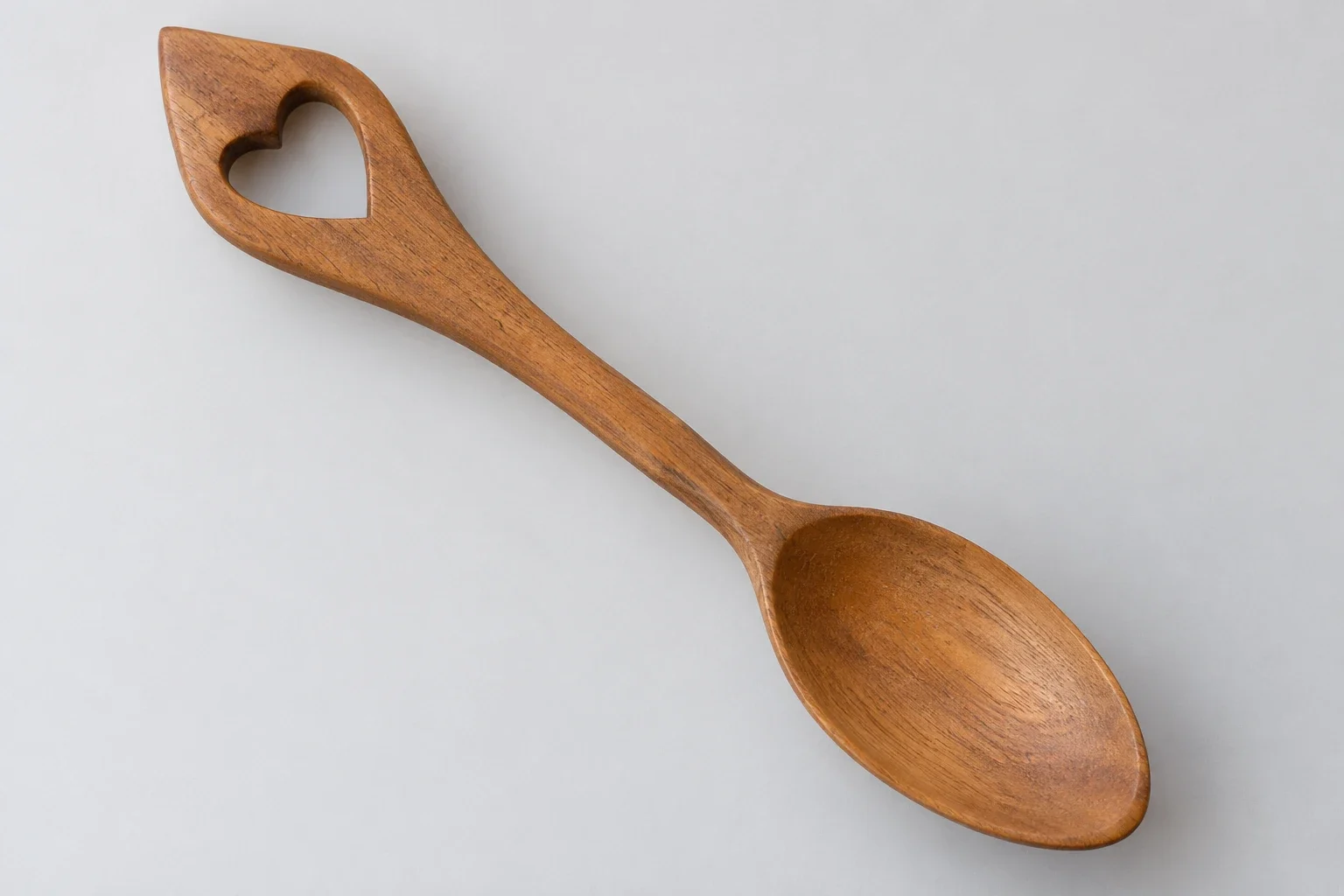 AI-generated illustration: A plain wooden spoon with a broad handle containing one open heart and a single shallow bowl.